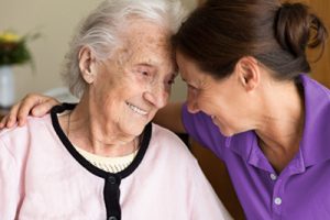 Dementia and Occupational Therapy - Home caregiver and senior adult woman