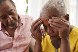 Senior Man Comforting Woman